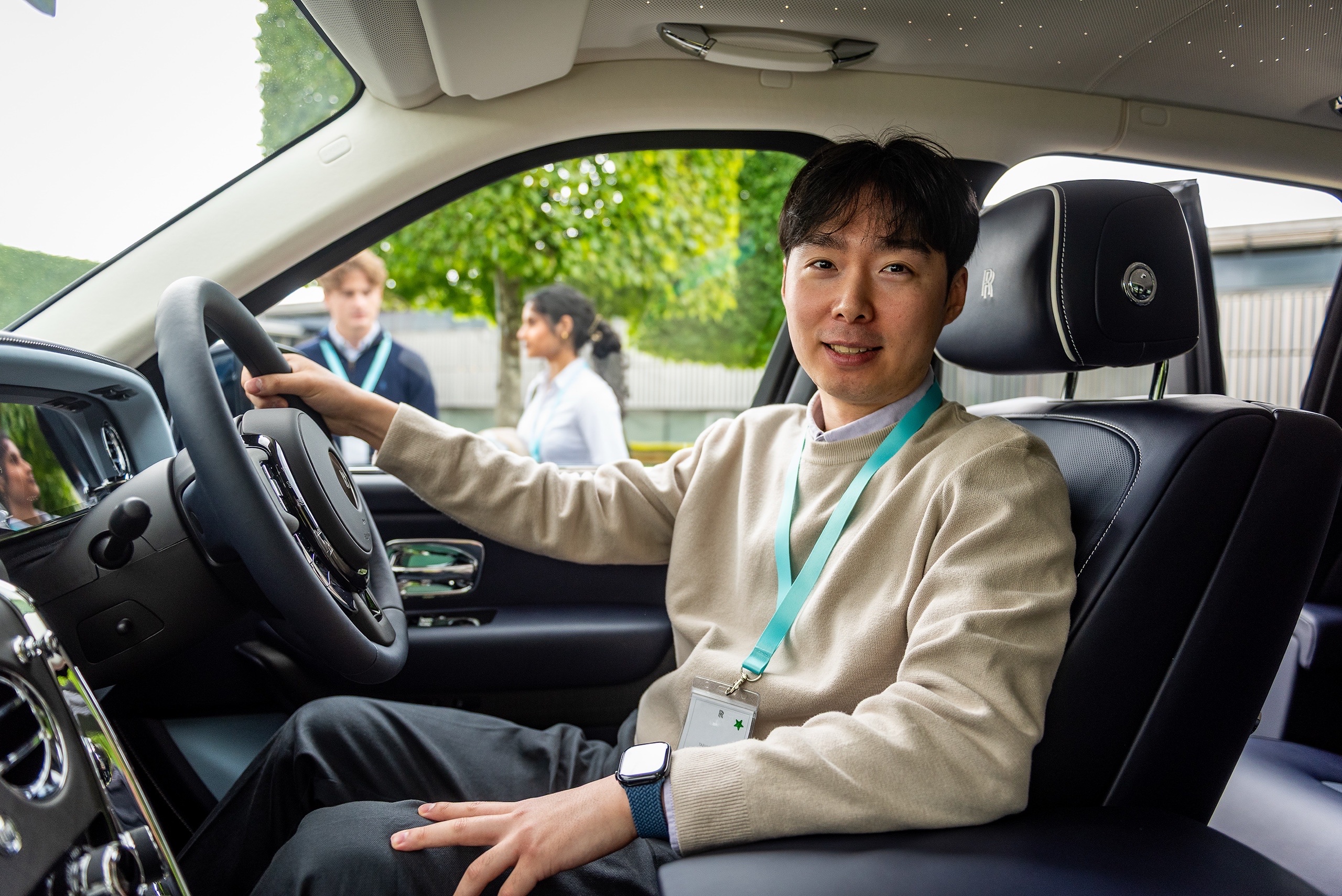 Taehyeong Kim in the driver's seat of a Rolls-Royce